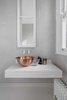 Modern home with Bath Room and Vessel Sink. Pros: Also known as composite quartz, engineered quartz comes in a wide range of colors and textures with the general durability of real stone slabs, but with the ease of manufacturing and installation of a man-made product. As a result, engineered quartz isn’t as expensive as other natural stone countertops.
Cons: On the other hand, customers can expect to see these qualities reflected in the price of engineered quartz, which can be on the higher end. Quartz also doesn’t handle extreme heat as well as granite does. Photo of Brass Is Everywhere at this Classical-Meets-Modern Flat in London