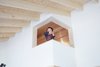 Modern home with Kids Room and Playroom Room Type. Takuma strikes a pose from the loft lookout as seen from the second floor. The loft is used for storage as well as a place for some peace and quiet. Photo 10 of Yanagisaki House
