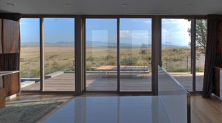 The bedframe, also custom and seen here without a mattress, rests in the center of the living space and offers almost panoramic views.