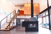 Modern home with Living Room, Two-Sided Fireplace, and Concrete Floor. A 3,500-square-foot home in upstate New York was designed by the architecture firm Mapos with simple materials and passive design principles. The contemporary fireplace, which sits on buffed concrete flooring at the center of the ground floor, was custom-made by Mapos. Photo 3 of Hudson Valley Dream Retreat