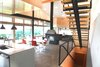The couple plan to retire in this home; its capacious interior is designed to host multiple generations of family. IKEA lights stands over a Kohler faucet in the kitchen. Photo 5 of Hudson Valley Dream Retreat modern home