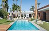 Modern home with Outdoor, Large Patio, Porch, Deck, Wood Patio, Porch, Deck, Large Pools, Tubs, Shower, Swimming Pools, Tubs, Shower, and Back Yard. Architect Sean Lockyer designed a 5,760-square-foot concrete, stucco, and ipe home for a couple and their three children in the Southern California desert town of Indian Wells. The residents selected the home's furnishings, including the Royal Botania chaise lounges. Photo of 47+ Midcentury Modern Homes Across America