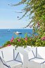 Modern home with Outdoor, Trees, Back Yard, and Flowers. The color of royal blue appears throughout the hotel and pops against the bright white foundations—both indoors and out. Photo 3 of Myconian Ambassador Hotel