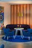 Modern home with Living Room, Floor Lighting, Rug Floor, Chair, Sofa, and Coffee Tables. To welcome eager travelers, the reception area is filled with various seating areas and brimming with contemporary furnishings that divert drastically from the neighboring classic Greek architecture. Photo 6 of Myconian Ambassador Hotel