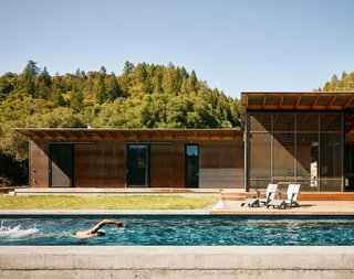 A modern interpretation of the traditional dogtrot home, Camp Baird comprises two cabins placed along an L-shaped orientation. An elongated, solar-heated lap pool runs the length of the south-facing side, alongside an expansive ipe deck that measures nearly 1,600 square feet. 