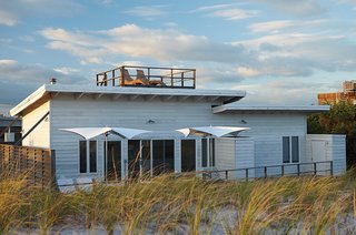 The steps lead to a roof deck, where the owners can enjoy sweeping views of the ocean.