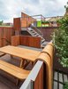 Modern home with Outdoor, Rooftop, Vertical Fences, Wall, Wood Fences, Wall, Wood Patio, Porch, Deck, and Horizontal Fences, Wall. A sculptural picnic table by artist Michael Beitz flows over the fence like a waterfall. Photo of 30+ Best Modern Fences