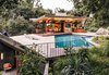 Modern home with Outdoor, Back Yard, Side Yard, Front Yard, Trees, Grass, Hardscapes, Walkways, Swimming Pools, Tubs, Shower, Rooftop, Concrete Patio, Porch, Deck, Metal Fences, Wall, and Hanging Lighting. Delighted with the result, they requested additional structures, including a pool house with a dining area that opens to the outdoors. Rising from the edge of the pool deck, a planted overhang shelters a gym and sauna below. Photo of 47+ Midcentury Modern Homes Across America