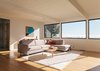 Modern home with Living Room, Sofa, Sectional, Coffee Tables, Light Hardwood Floor, and Rug Floor. A painting by Karl Benjamin hangs in the dining area beyond. The living room features a Noguchi Rudder table and artwork by Tony DeLap. Photo of 47+ Midcentury Modern Homes Across America