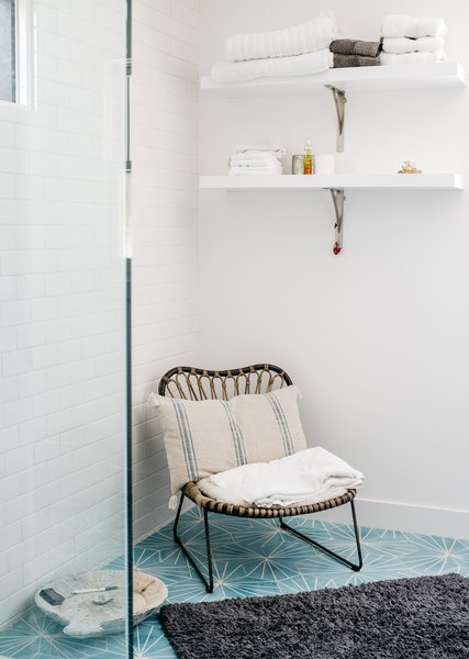 Dandelion cement tiles from Marrakech Design adorn the master bathroom. The chair is from Lawson Fenning.