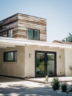 The exterior, which was taken down to the studs and rebuilt, pairs the original concrete block with reclaimed hemlock, which clads two sides of the upstairs addition.