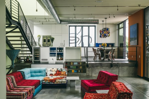 Inside, a colorful sectional softens the industrial vibe.