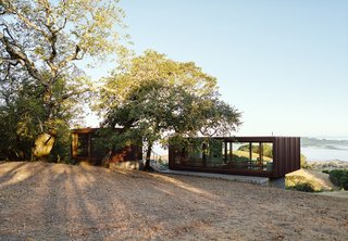 The weeHouse exteriors are clad in corrugated Cor-Ten, but with a custom pattern of folds to create an organic randomness. The foundations were designed with a shallow recess around the top to make the modules look like they’re hovering. After they bought the property in early 2014, the Siegels camped there for two summers while they saved up money and planned a permanent structure. In his research, BJ came across this design, a customizable prefab house by Alchemy Architects. "Of all the things that I found, I was drawn to that one because it was absolutely the simplest and cleanest," he says.