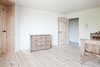 Modern home with Bedroom, Light Hardwood Floor, and Dresser. Two bedrooms occupy the second floor. This one, outfitted with stone pine furniture, looks out at a steep meadow. Photo 10 of La Pedevilla