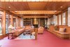 In the family room—which also holds a gold leaf-covered concrete fireplace—large skylights run the width of the space. Photo 8 of Tirranna modern home