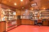 Though the appliances have been updated, the rest of the kitchen is original, including the cabinets, piano hinges, and the painted glass windows on the ceiling. Photo 10 of Tirranna modern home