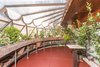 The greenhouse features windows that are finished with a scalloped metal treatment. Gricar points out that the metal scalloping can also be found on the Guggenheim—solidifying a connection to the other project that was on Wright's mind at the time. Photo 2 of Tirranna modern home