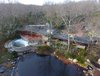An overhead drone view shows the 15-acre property that also hosts a heated pool, river, tennis court, barn/stable, sculpture path, and rooftop observatory. The original landscaping was designed by Frank Okamura and Charles Middeleer. Photo of Tirranna modern home