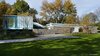 Looking towards the residence, you’ll see the original main house to the right, and the steel and glass addition to the left—which are connected by stairways that lead up on one direction, and down on the other. The main house contains the communal living spaces while the addition holds the bedrooms. Photo 2 of Marcel Breuer's New Canaan Home modern home