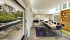 Modern home with Dining Room, Table, and Chair. Listing agent Sherri Kielland explains that in order to preserve the radiant heated floor, she chiseled the original floor off while cataloging all the stones. After laying down the new radiant heated bluestone floors, she pieced it back together like a puzzle. She also dug a well under the kitchen area to house the mechanicals of the house. Photo 6 of Marcel Breuer's New Canaan Home