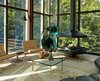 Out of the 3,544 square feet of the residence, 1,000 square feet of it comes from the pavilion. The corner of the open living room contains a suspended fireplace, oversized German speakers, and a pair of Barcelona chairs by Ludwig Mies Van Der Rohe. Photo 5 of Wiley House modern home