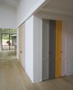 Playful panels of color on closet doors and the stair risers break up the white walls. The homeowner explains, “I took as inspiration Imi Knoebel, whose work I had seen at the Dia Beacon, and who works with large shapes of color placed in relationship to one another.” Photo 2 of Beetlebung modern home