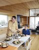 Modern home with Dining Room, Table, Chair, and Light Hardwood Floor. At the IKEA dining table, David Peters and his son, Dashel, enjoy a meal from a Paderno stainless-steel pot made on Prince Edward Island. Photo 3 of Sliding House