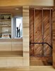 Stairwells and service areas utilize knotted planks. “It’s akin to stepping offstage into the wings,” resident Rhonda Rubinstein says of the transition. Photo 6 of Sliding House modern home