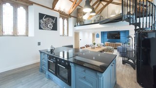 A former 19th-century Methodist chapel in the countryside near Padstow, Seraphina was transformed into an open-plan, two-level home with vaulted ceilings and stained-glass windows. 