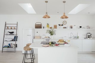 This modern beach house, just a mile from the harbor town of Porthleven, has an open kitchen, a double-side fireplace, and sweeping ocean views.