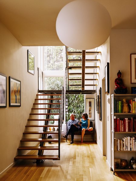 Louis did much of the woodworking in the house, including the fabrication of the  white oak stair treads. The ironwork was crafted by Alex and Gio Welding. A Glo Ball pendant by Jasper Morrison for Flos hangs in front of the staircase.