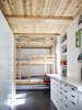 A three-level bunk bed with an additional trundle furnishes the children’s room on the first floor; the cabinetry and drawers are from IKEA. Photo 3 of Cyclopean House modern home