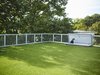 Modern home with Exterior, Green Roof Material, and House Building Type. A hatch door leads to the roof deck, which is lined with artificial turf. Photo 4 of Cyclopean House