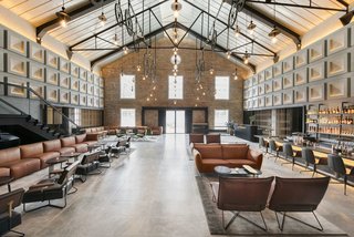 Designed by Asylum and Zarch Collaborative, the converted warehouse boasts a lobby with vaulted ceilings that puts a spotlight on the original pulley systems that were commonly found in godowns.