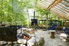 Modern home with Outdoor, Trees, Front Yard, Woodland, Back Yard, Side Yard, Shrubs, and Boulders. Joel, a landscape designer, created “a series of outdoor rooms,” including an alfresco kitchen that is sheltered beneath a cedar trellis. The Butterfly chairs are from Fresh Home and Garden in Toronto. Photo 6 of The Land House