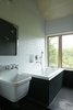 Modern home with Bath Room, Soaking Tub, Drop In Tub, Subway Tile Wall, and Wall Mount Sink. In the bathroom, the sink is by Kohler and the tub is by Maax. Photo 8 of The Land House