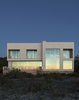 Modern home with Exterior, House Building Type, Flat RoofLine, and Stone Siding Material. When Superstorm Sandy struck the East Coast in fall 2012, Margaret and Bob Bombara were in the middle of planning their long-awaited beach house on Long Island’s North Fork. The disaster, which flooded their main home in Queens, gave them pause. For architect John Berg, it underscored a vital fact—the Bombaras’ vacation house would need to be able to stand up to high wind, heavy rain, and intense storm surges. Photo 2 of North Sea House