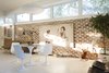 Modern home with Dining Room, Table, Chair, Pendant Lighting, and Table Lighting. An existing brick wall was dismantled, cleaned, and rebuilt to celebrate its patina . It now showcases an artwork by Blake Boyd. Photo 2 of Emerald Street Residence