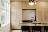 In the renovated kitchen, a Lacanche range is surrounded by built-in storage. A state-of-the-art wall-mounted ES2 Strietman brass-and-copper espresso maker by Dutch designer Wouter Strietman adds a jewelry-like touch to the cook space. Photo 9 of Skibsted Residence modern home