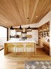 Modern home with Light Hardwood Floor, Table, Chair, Wood Cabinet, and Kitchen. Swell lights by Pablo hang above Hot Mesh stools from Blu Dot. The millwork is by J. Spix Fine Cabinets. Photo 3 of Dogpatch Cottage