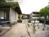 Modern home with Shrubs, Concrete Counter, Stone Patio, Porch, Deck, Ceiling Lighting, Hardscapes, Den Room Type, Concrete Floor, Chair, and Outdoor. The bocce court sits between the master bedroom patio and an outdoor dining area featuring Jean-Marie Massaud’s Seashell chairs from Dedon. To bring in natural light while limiting direct exposure, the couple designed a horizontal window for the music room. Photo 8 of Wessel Residence