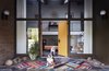 Modern home with Doors, Exterior, Swing Door Type, and Wood. By scouring shops, sales, and auctions, George Marrone amassed a giant trove of postwar furniture. He and his partner, Michael Nocera, applied that same work ethic to a 1959 home in Wilmington, Delaware, which they patched up over two years. The couple’s bulldogs stand guard at the flagstone entrance. The door, still with its Space Age knobs, is painted Flaming Torch by Behr. The brass wallhanging above the landing is by C. Jeré. Photo 2 of The Marrone/Nocera Residence