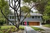 Modern home with Front Yard, Trees, Shrubs, Grass, Hardscapes, Gardens, Walkways, Exterior, House, and Wood Siding Material. “We looked at so many colonials and couldn’t imagine what we’d do with all the tiny rooms,” says Dianne Bruning, who with her husband, David Owen, enlisted architect Lou Balodemas to update a 1968 home outside of Chevy Chase, Maryland. Photo 2 of The Bruning/Owen Residence