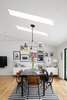 Modern home with Dining Room, Ceiling Lighting, Table, Light Hardwood Floor, Chair, Storage, and Shelves. The dining area (above right) boasts circa-1955 Friso Kramer chairs. Photo 4 of The Bruning/Owen Residence