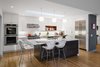 Modern home with Kitchen, White Cabinet, Refrigerator, Medium Hardwood Floor, Wall Oven, Ceiling Lighting, Range, Range Hood, and Drop In Sink. In the renovated kitchen space, Dianne chose quartz counters in Blizzard by Caesarstone. Photo 5 of The Bruning/Owen Residence