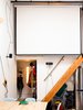 Modern home with Staircase and Wood Tread. Max likes to do screenings for friends: “The first time I hosted I showed Planet Earth. Next up is Koyaanisqatsi: Life Out of Balance, a 1982 experimental film by Godfrey Reggio with music by Philip Glass.” Photo 9 of Max's Apartment