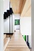 Modern home with Hallway and Light Hardwood Floor. Architects Marie-Claude Hamelin and Loukas Yiacouvakis connected the home’s three levels in dramatic fashion. Ash treads float on a steel stringer from the ground floor to the mezzanine. Photo 6 of La Colombière
