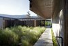 Modern home with Outdoor, Side Yard, Shrubs, Grass, Hardscapes, Walkways, and Concrete Patio, Porch, Deck. All of the plants are native to the area. “I was trying to re-create what I have out my front door, where the park starts,” says Jon, who worked on the landscaping with Jones. “The garden is also super low-impact. I don’t water it at all, and my kill rate is less than five percent.” Photo 5 of Friesen-Wong Residence