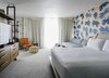 Modern home with Bedroom, Carpet Floor, Bench, Dresser, Chair, and Bed. For the Portland-based creative agency that’s responsible for the entire project, OMFGCO, it actually started out as a breezy assignment that included creating the hotel’s name, brand, and story. However, the project quickly expanded to be much more than that—including the task of creating everything from the concept and branding, to the interior design of the rooms and public spaces. Needless to say, it quickly became the biggest project they’ve ever taken on. Photo of The Laylow