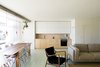 Modern home with Kitchen, White Cabinet, Wood Cabinet, Wood Counter, Ceramic Tile Floor, Pendant Lighting, Cooktops, Floor Lighting, and Drop In Sink. A Nockeby sofa by Ikea, a 45 Chair by Finn Juhl, and an Egg Gold coffee table by Kare are featured in the living room space.
-
Lisbon, Portugal
Dwell Magazine : July / August 2017 Photo 6 of The Henriques/Moreira Residence